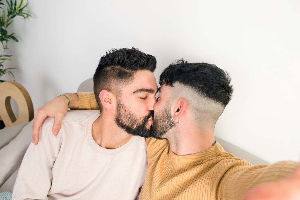 close-up-romantic-young-gay-couple-kissing-taking-selfie